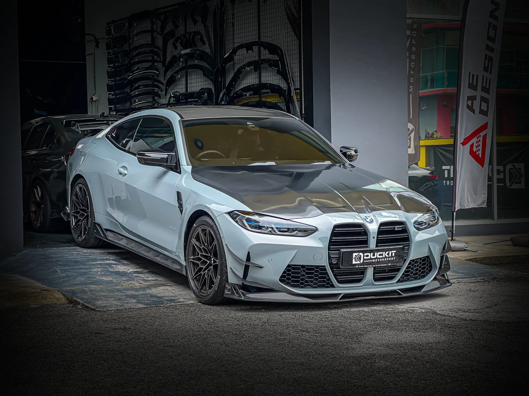 White BMW M4 G82 with gloss black grille in the workshop bay