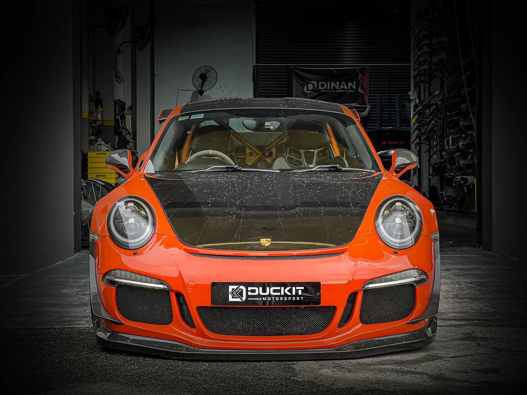 Orange Porsche 911 GT3 RS in the Duckit workshop